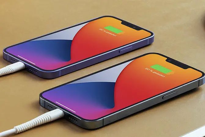 Zwei Smartphones nebeneinander, die per Kabel auf einer braunen Oberfläche aufgeladen werden, beide zeigen 50 % Ladezustand an.